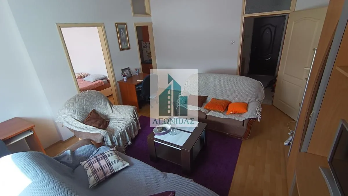 Furnished living room with a sofa set, coffee table, and view of the hallway.