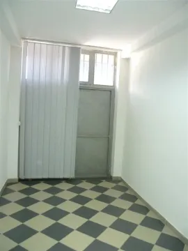 An empty room with checkered flooring and white walls. - image 5