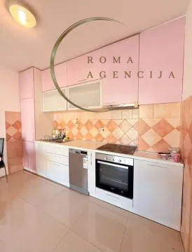 Smaller kitchen with pink upper cabinets and built-in appliances. - image 2