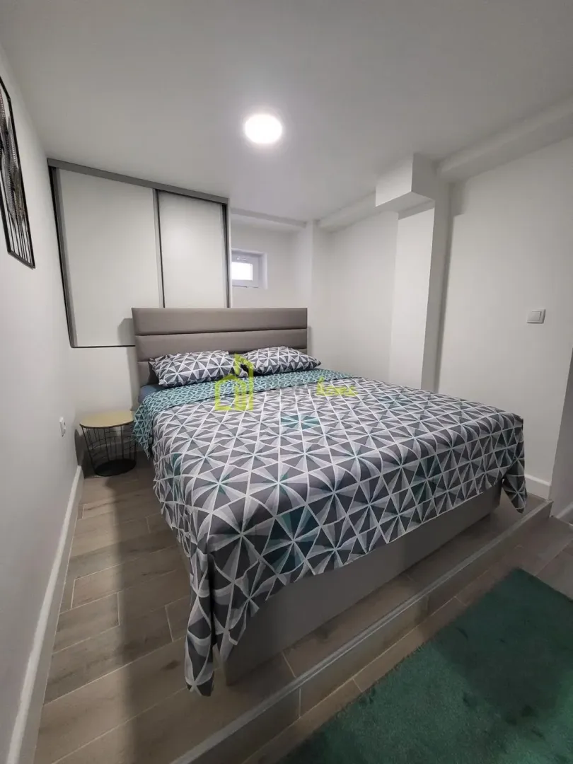 Furnished bedroom with a double bed and built-in wardrobe.
