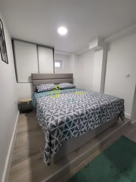 Furnished bedroom with a double bed and built-in wardrobe. - image 6