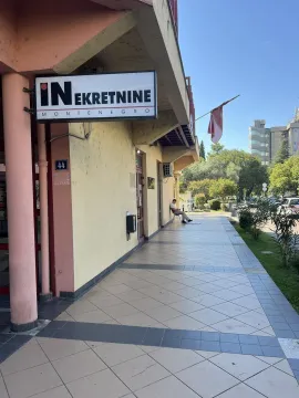 Entrance to a commercial space with a sign on the building facade. - image 8