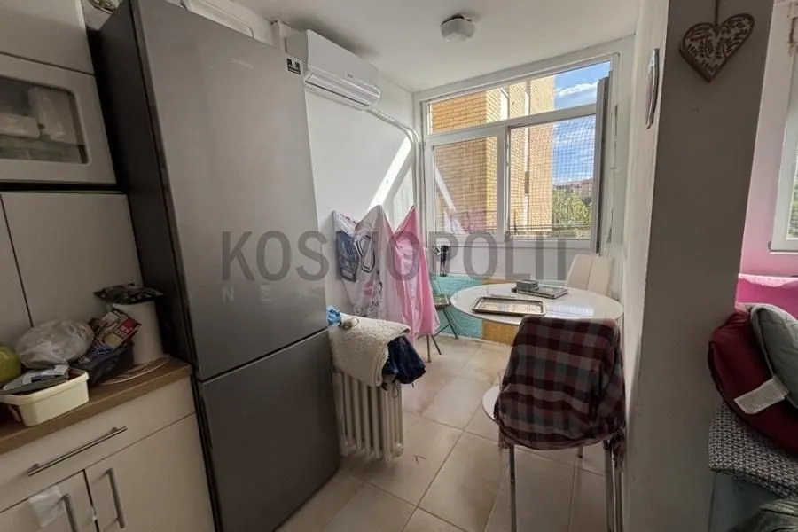 Kitchen with dining area and refrigerator.