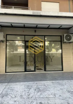 Exterior view of commercial space with large glass storefront. - image 8