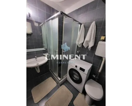 Bathroom with a shower cabin, washbasin, and washing machine. - image 6