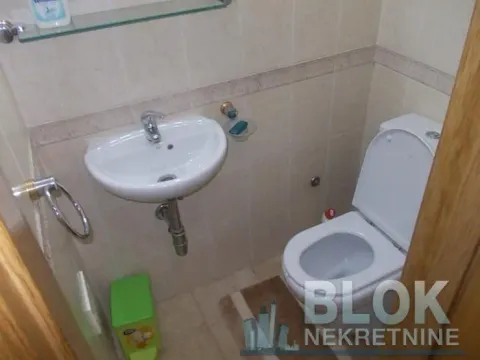 Smaller bathroom with a washbasin and toilet bowl tiled with ceramic tiles. - image 6