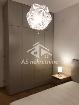Spavaća soba sa velikim ugradnim garderoberom i krevetom. - image 14