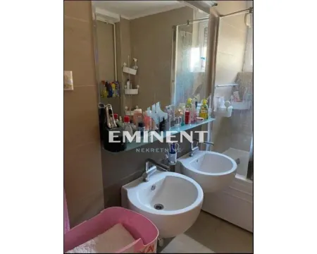 Bathroom with two washbasins, a large mirror, and a bathtub. - image 12