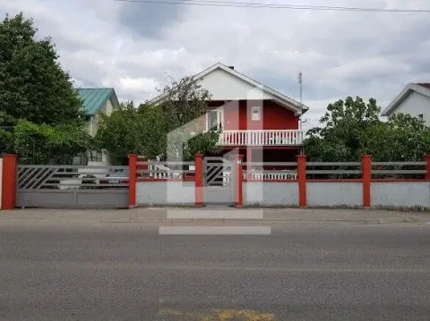 View of the front facade of the house with a yard fence and gate. - image 11