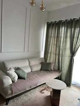 Decorated living room with a sofa, coffee table and curtains. - image 3