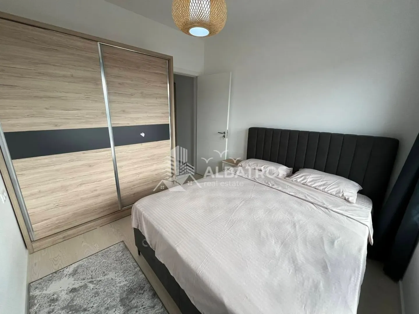 Bedroom with a double bed and a large fitted wardrobe.