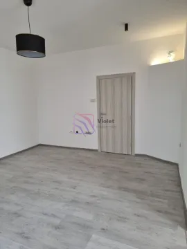 Empty room with laminate flooring and a wooden door. - image 3