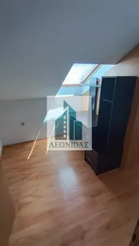 Attic room with laminate flooring and a desk. - image 2