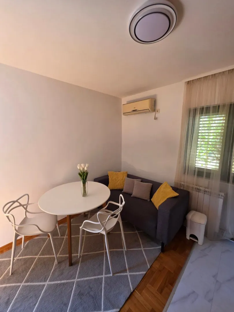 Small living room with a seating set and a dining table.