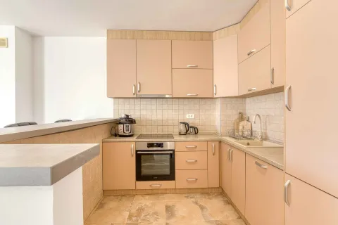 Kitchen equipped with wooden cabinetry, a stove, and a sink. - image 9