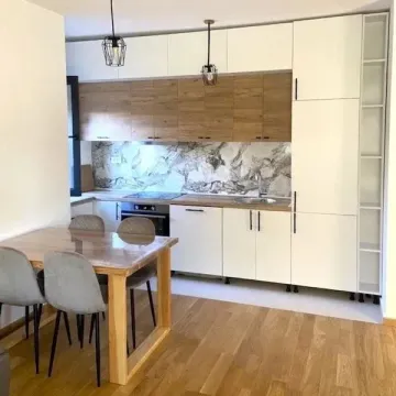 Modern kitchen with a dining table and chairs. - image 2