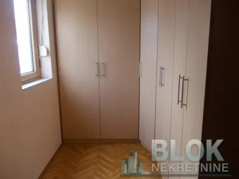 Smaller bedroom with a built-in wardrobe and wooden flooring. - image 10