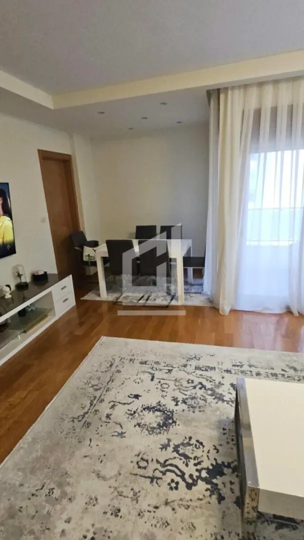 Living room with a dining area and parquet flooring.