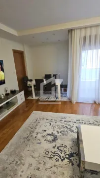 Living room with a dining area and parquet flooring. - image 3