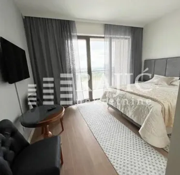 Modern bedroom with a double bed, TV, and access to the terrace. - image 6