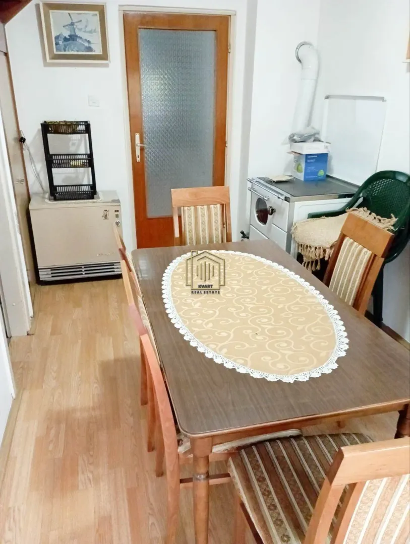 Dining room with a wooden table and chairs.