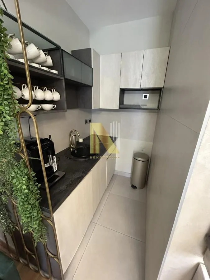 Small kitchen with modern cabinets and a coffee machine.