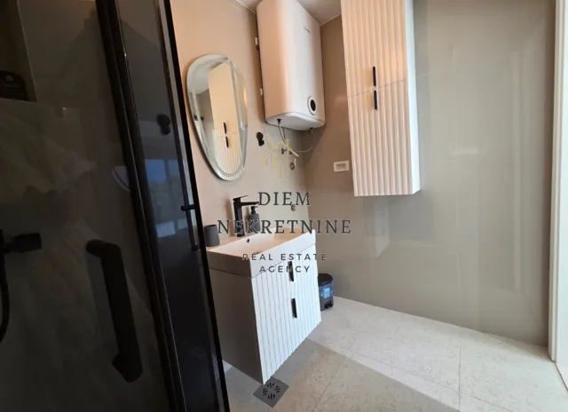 Modern bathroom with a vanity and shower enclosure.
