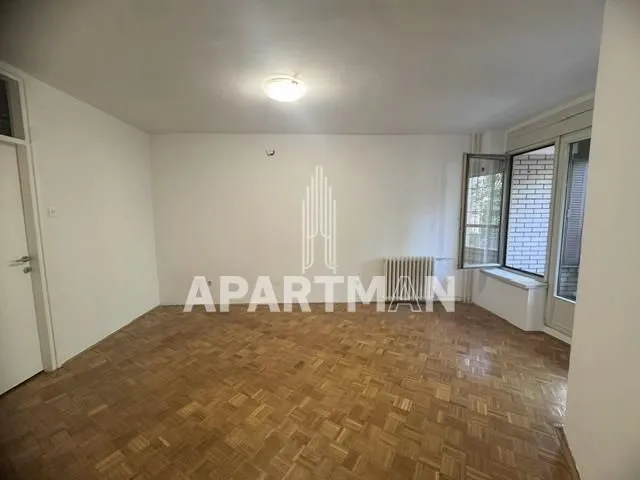Empty room with parquet flooring and access to a terrace.