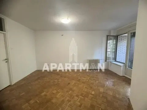 Empty room with parquet flooring and access to a terrace. - image 5