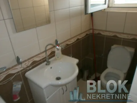 Small bathroom with a washbasin, mirror, and toilet bowl. - image 12