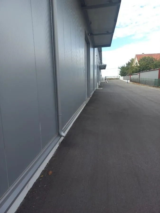 View of the exterior part of the building with an asphalt driveway.