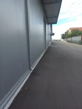 View of the exterior part of the building with an asphalt driveway. - image 4