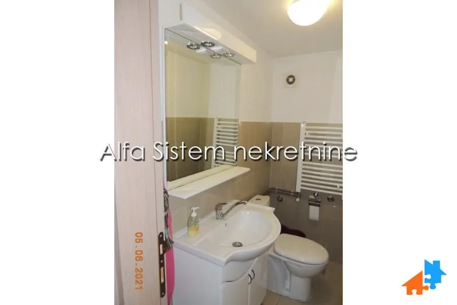Small bathroom with a sink, mirror, and toilet.