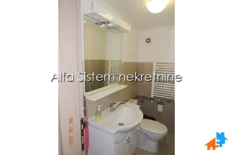 Small bathroom with a sink, mirror, and toilet. - image 14