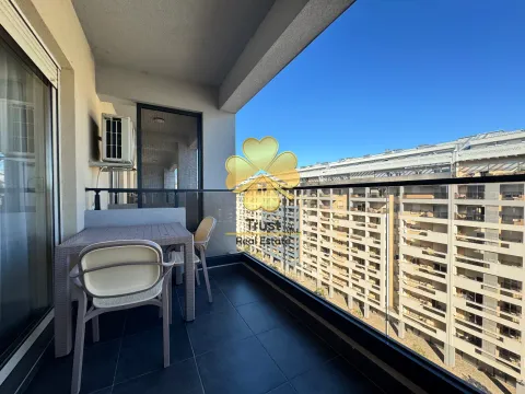 Furnished terrace with a table and chairs and a view of buildings. - image 6