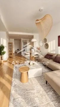 Living room with sofa, dining area, and wooden flooring. - image 4
