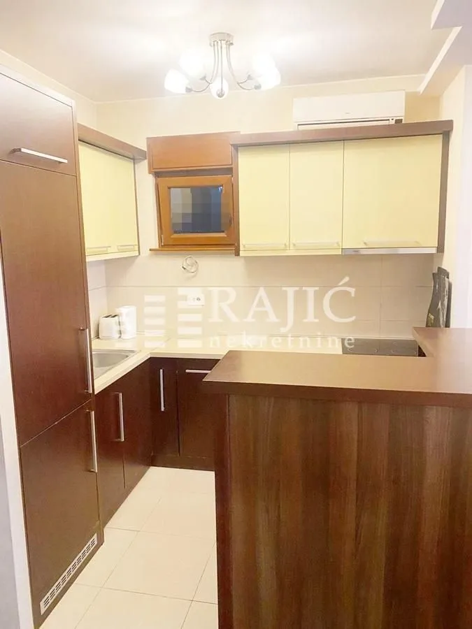 Small kitchen with brown cabinets and light countertops.