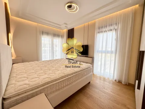 Modern bedroom with a double bed and large windows. - image 7