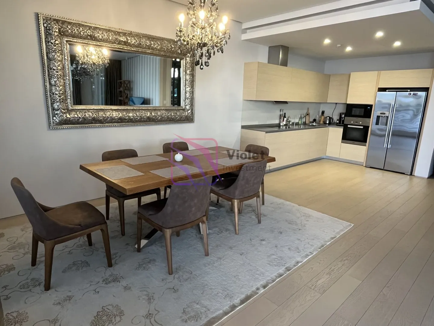 Open plan space featuring a dining area and a modern kitchen.