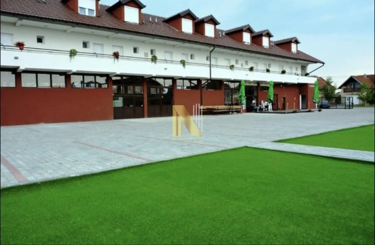 Exterior of the commercial building with a large courtyard and parking lot.