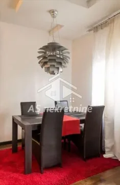 Dining area with a table, chairs, and a chandelier. - image 4
