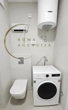 Savremeno opremljeno kupatilo sa WC šoljom, veš mašinom i bojlerom. - image 9