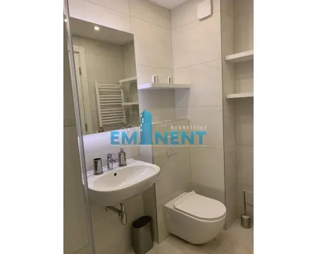 Modern bathroom equipped with a washbasin and a wall-mounted toilet. - image 8