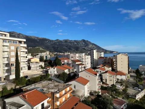View from the window showing the city, sea, and mountains in the background. - image 10