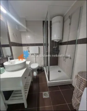Bathroom with a shower cabin, washbasin, and toilet. - image 10