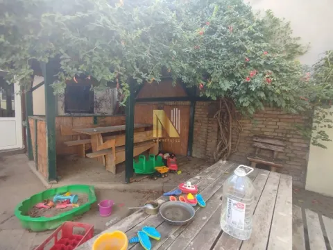 Yard with a wooden canopy, benches, and toys. - image 18