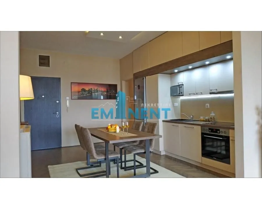 Modern kitchen with dining area and built-in appliances.