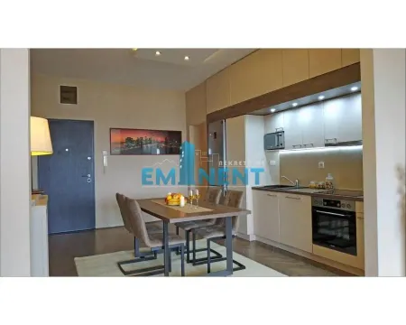 Modern kitchen with dining area and built-in appliances. - image 5