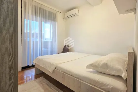 Smaller bedroom with a double bed, air conditioning, and balcony doors. - image 6
