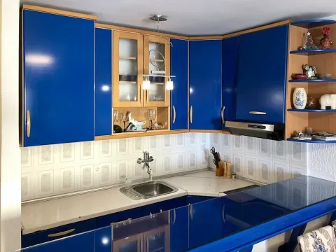 Kitchen with blue cabinets and a sink. - image 5